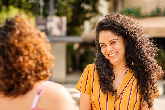 Two women chatting in a meeting on the street