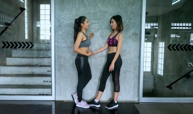 two women discussing after work out at gym.