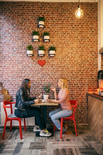 Two women enjoying crepes at pancake house