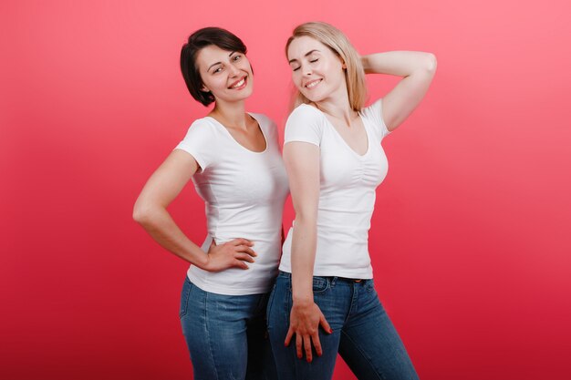 Two women have a funny time, looking satisfied.