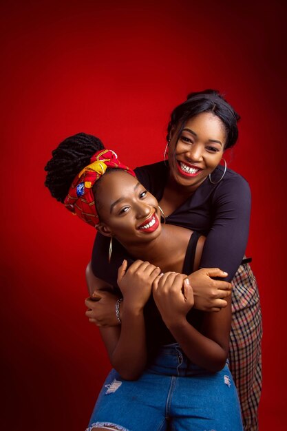 Two women hugging and one is wearing a colorful headband