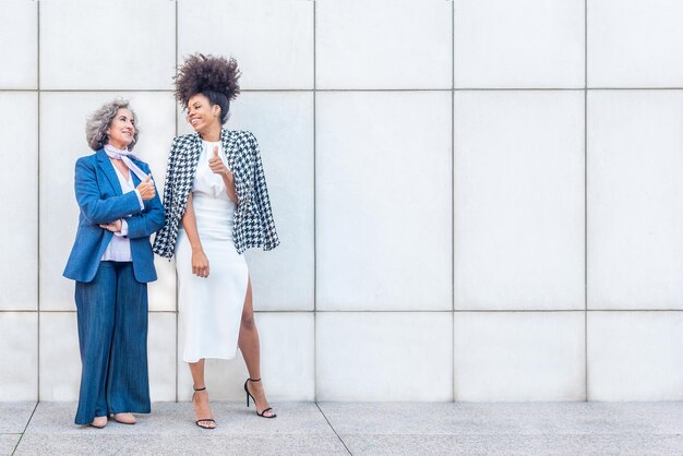 Two women laughing while enjoying a break from work