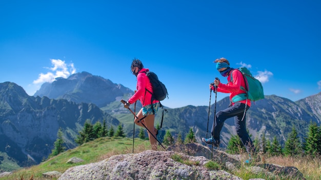 Two women in the mountains with mask