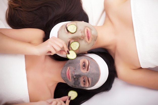 Two women in a spa with a mask on their faces