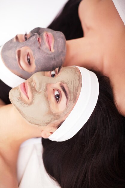 Two women in a spa with a mask on their faces