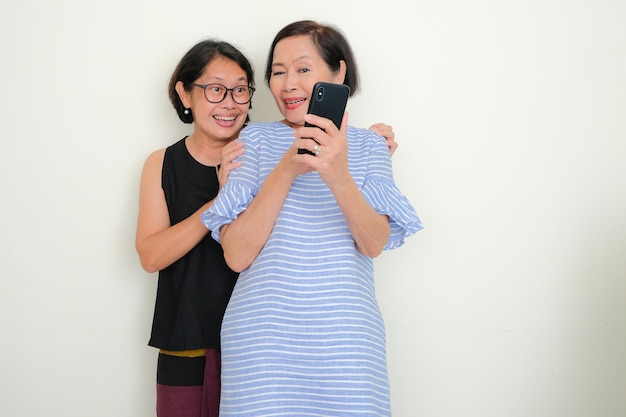 Two women standing and making a video call together