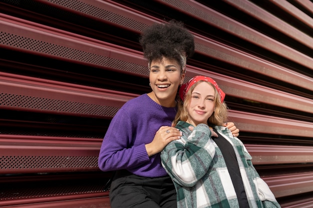 Two women on the street multiracial hand in hand