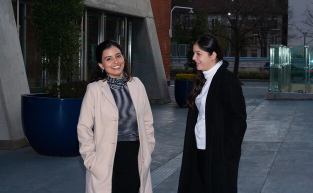 Two women talking walking outdoors