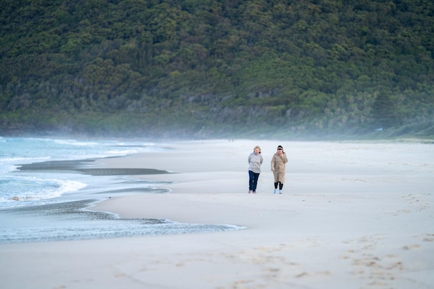 Two women walking on the beach