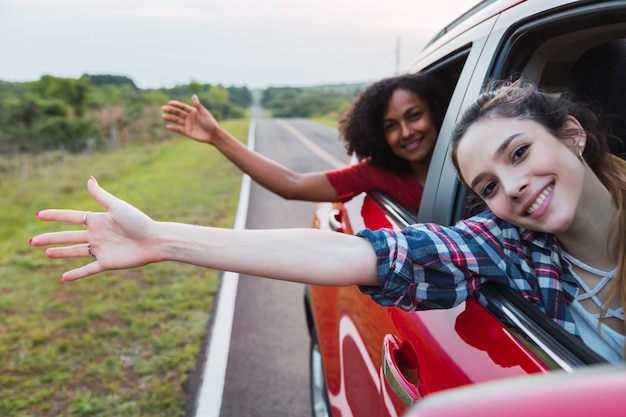 Two women at the window of a car.