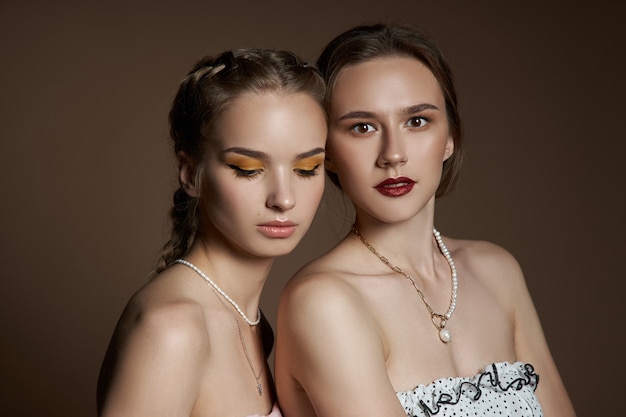 Two women with necklaces around their necks