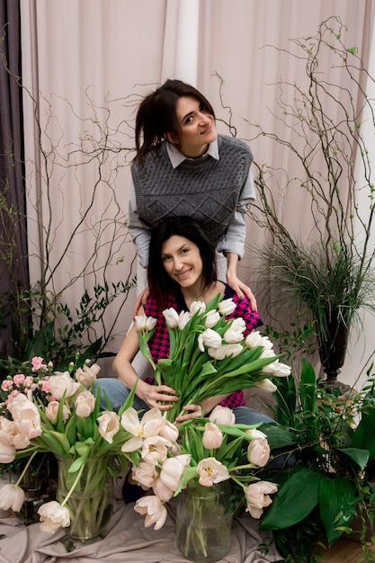 Two women with spring flowers tulips