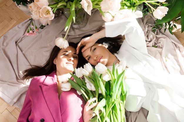 Two women with spring flowers tulips