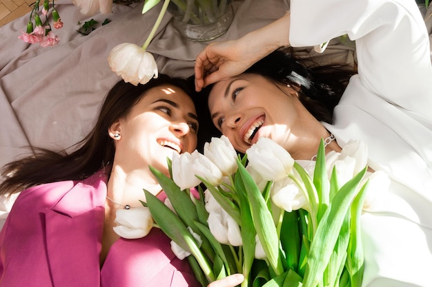 Two women with spring flowers tulips