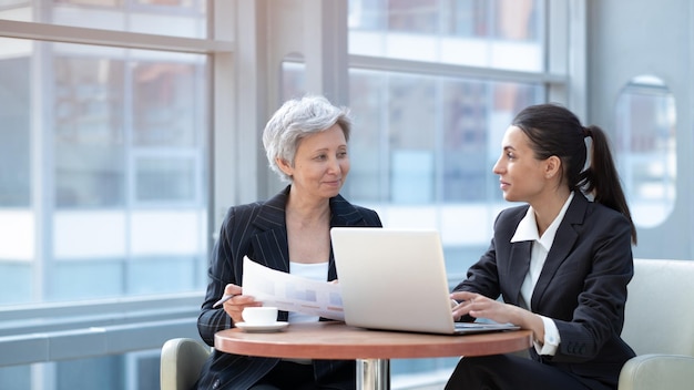 Two women working with laptop