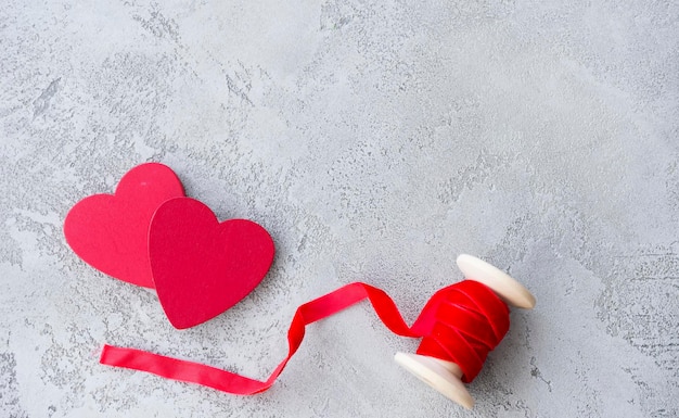 Photo two wooden hearts and place for text on a concrete background