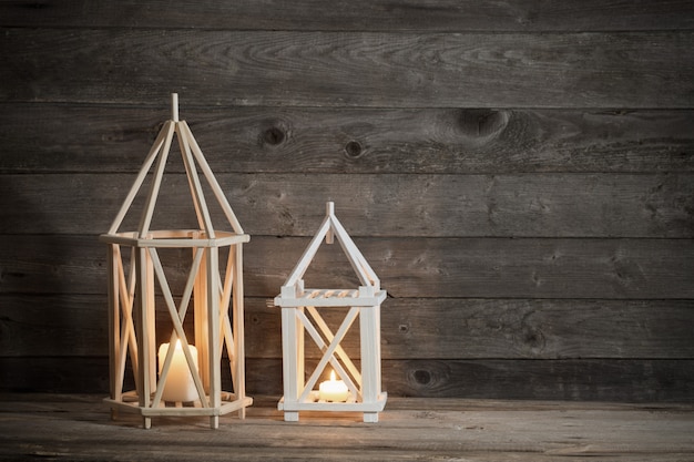 Two wooden lanterns on old rustic scene