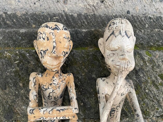 Two wooden statues with the words " think " on them.