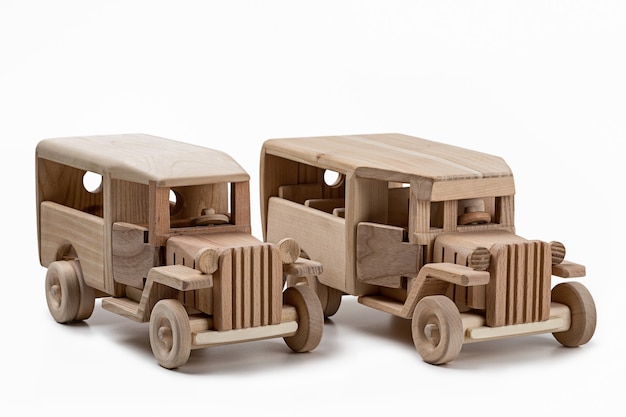 Two wooden vintage bus toys in the studio.