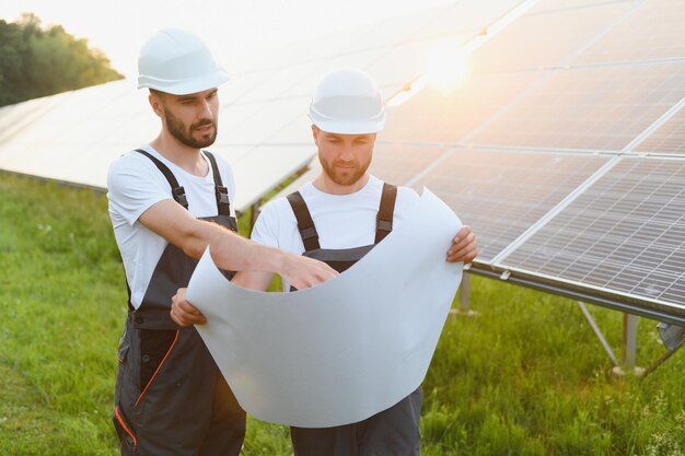 Two workers working on a solar panel