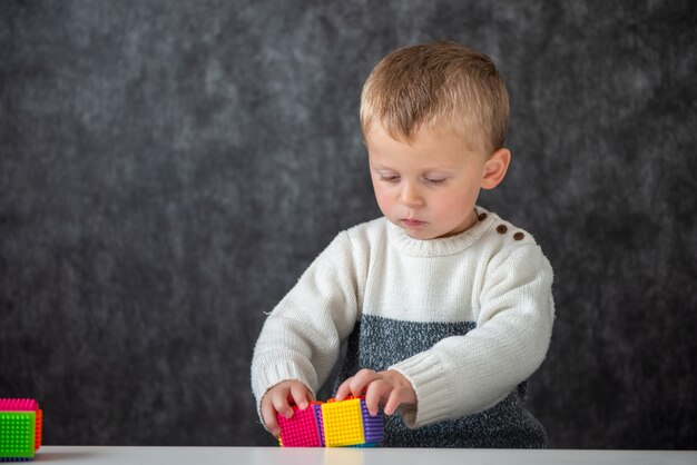 Two years old baby playing with cubes