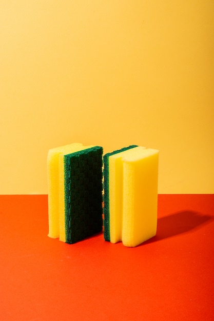 Two yellow and green sponges for cleaning and washing dishes