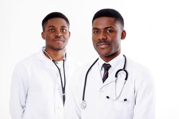 Two young african doctors on an isolated white with a phonendoscope