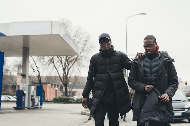 Two young african men crossing the street 