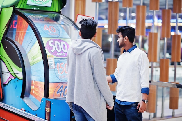 Two young asian guys play in fortune wheel to win at lottery\
big prize