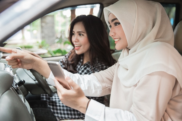 Two young asian women in the car