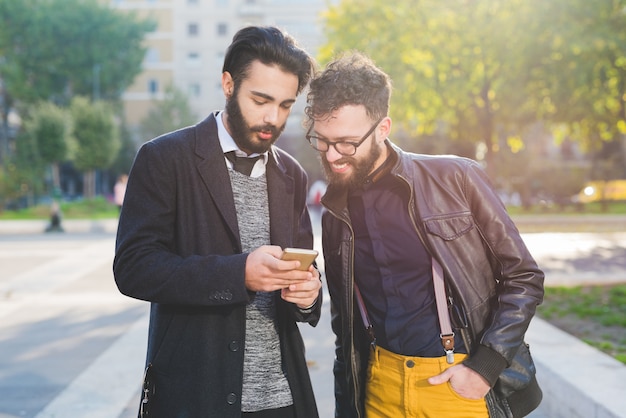 Two young bearded blonde and black hair modern businessman