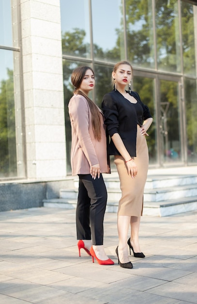 Two young beautiful business women outdoors