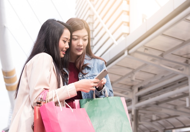 two young beautiful women shopping online in Mobile Phone