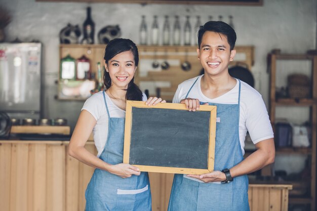 Two young business partner open their cafe