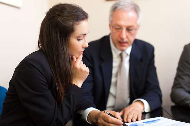 Two young business partners discussing plans or ideas at meeting