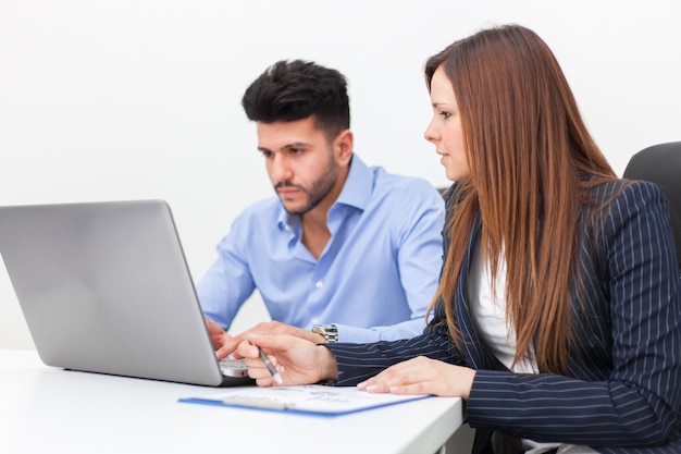 Two young business partners discussing plans or ideas at meeting