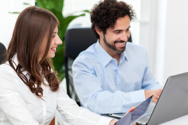 Two young business partners discussing plans or ideas at meeting