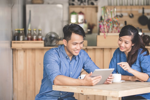 Two young business partners using tablet together