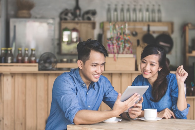 Two young business partners using tablet together