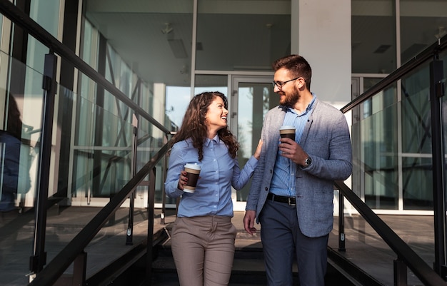 Two young business people standing and talking