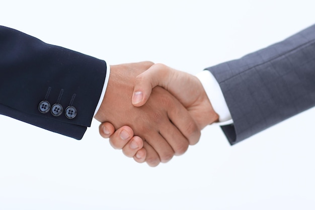 Two young businessman standing opposite each other and shake their hands