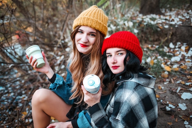 two young cheerful girls walk in the park