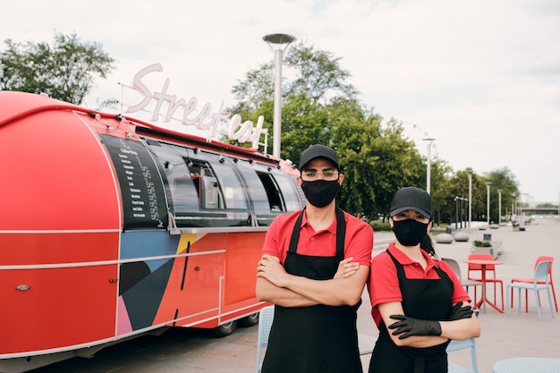 Photo two young clerks in uniform and protective masks