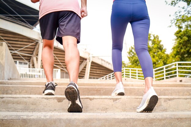 Two young couples in sportswear Run up the stairs for an outdoor workout early in the day