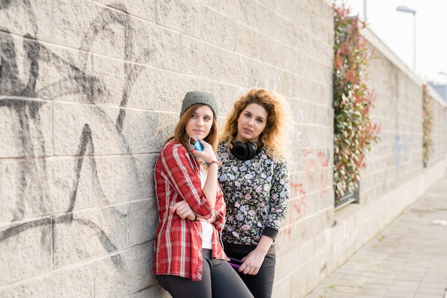 Two young curly and straight blonde hair woman