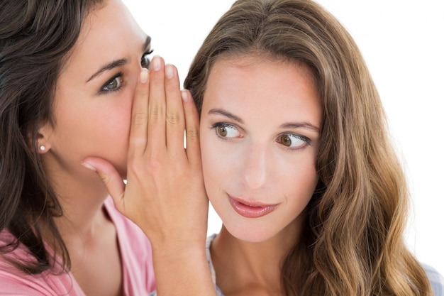 Two young female friends gossiping