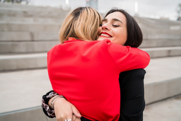 Two young friends hugging each other