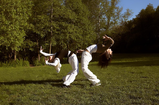 Two young girl jump in park