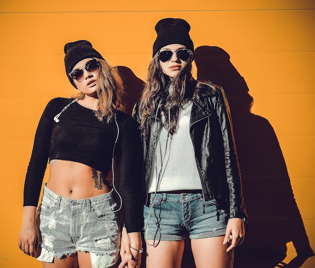 Two young girlfriends in sunglasses having fun. Lifestyle.