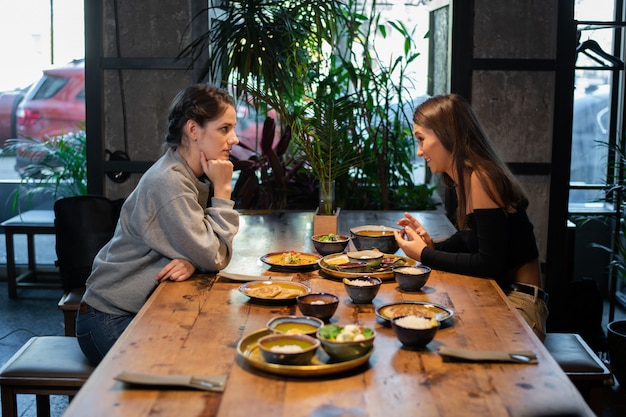 Two young girls having a business lunch at a cafe